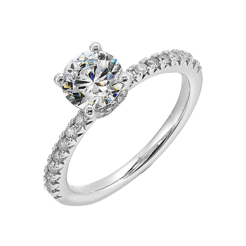 Round solitare meets sleek diamond pave offering timeless elegance.