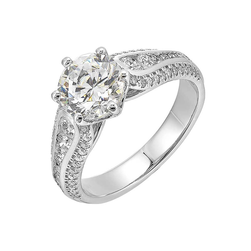 Stunning solitaire ring set in 6 prongs is a dazzling display of channel set diamonds in the center & pave on sides making the ring more appealing.