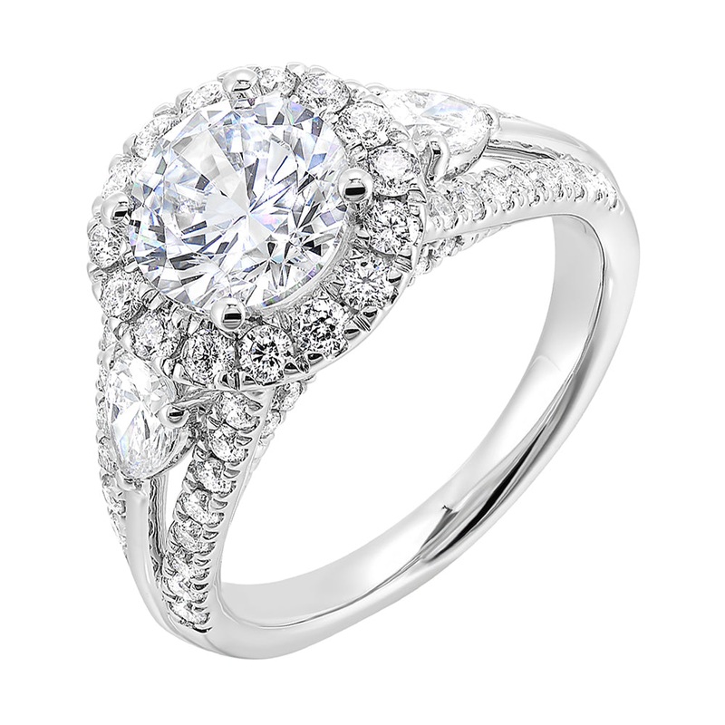 Start your love story with sparkles of this marquise and round diamond three stone engagement ring. The three rows shank have a beautiful split with pave studded diamonds on the sides.