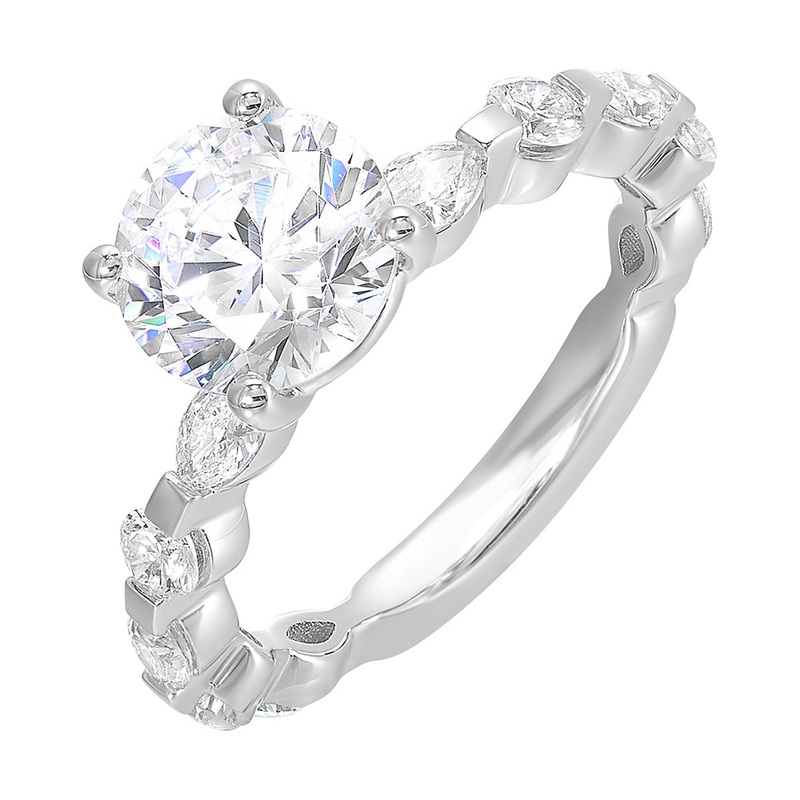 This engagement ring featues a sparkling round centre,  with alternating marquise and round brilliant diamonds in the band.