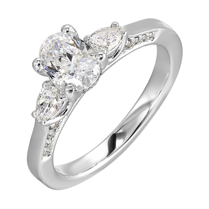 Three stone ring features an oval cut solitare nestled inbetween pear cut diamond,  all embellished with sparkling diamond accents in front.
