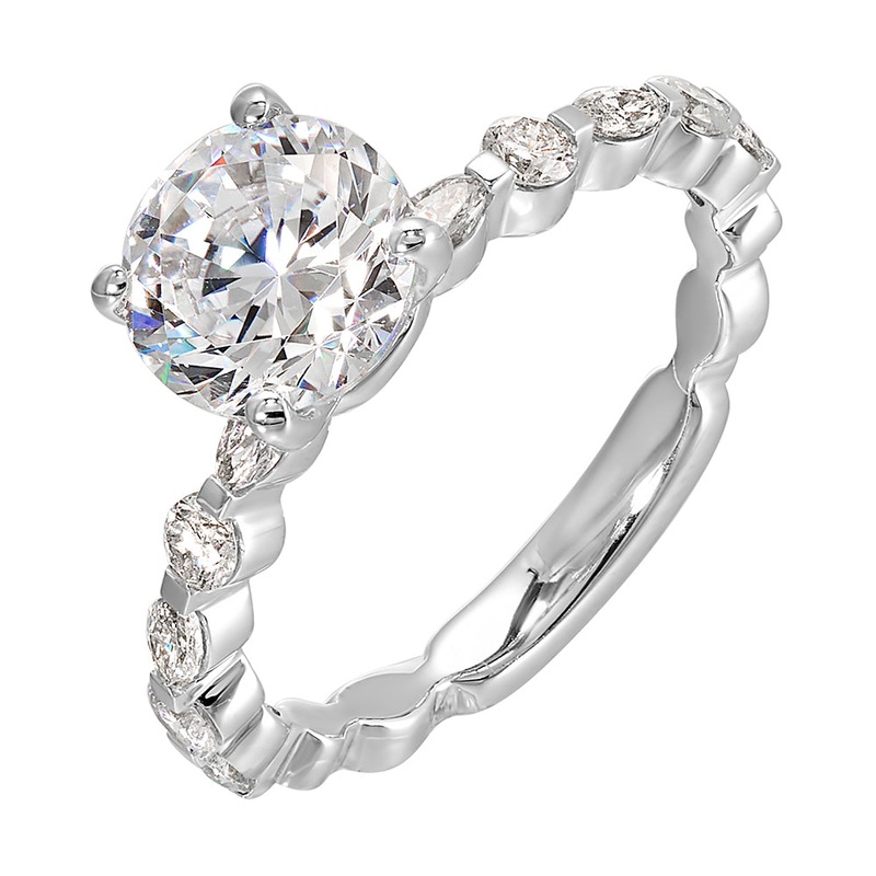 You are sure to cause a sensation with marqusie and round diamonds engagement ring highlighting the center solitare.
